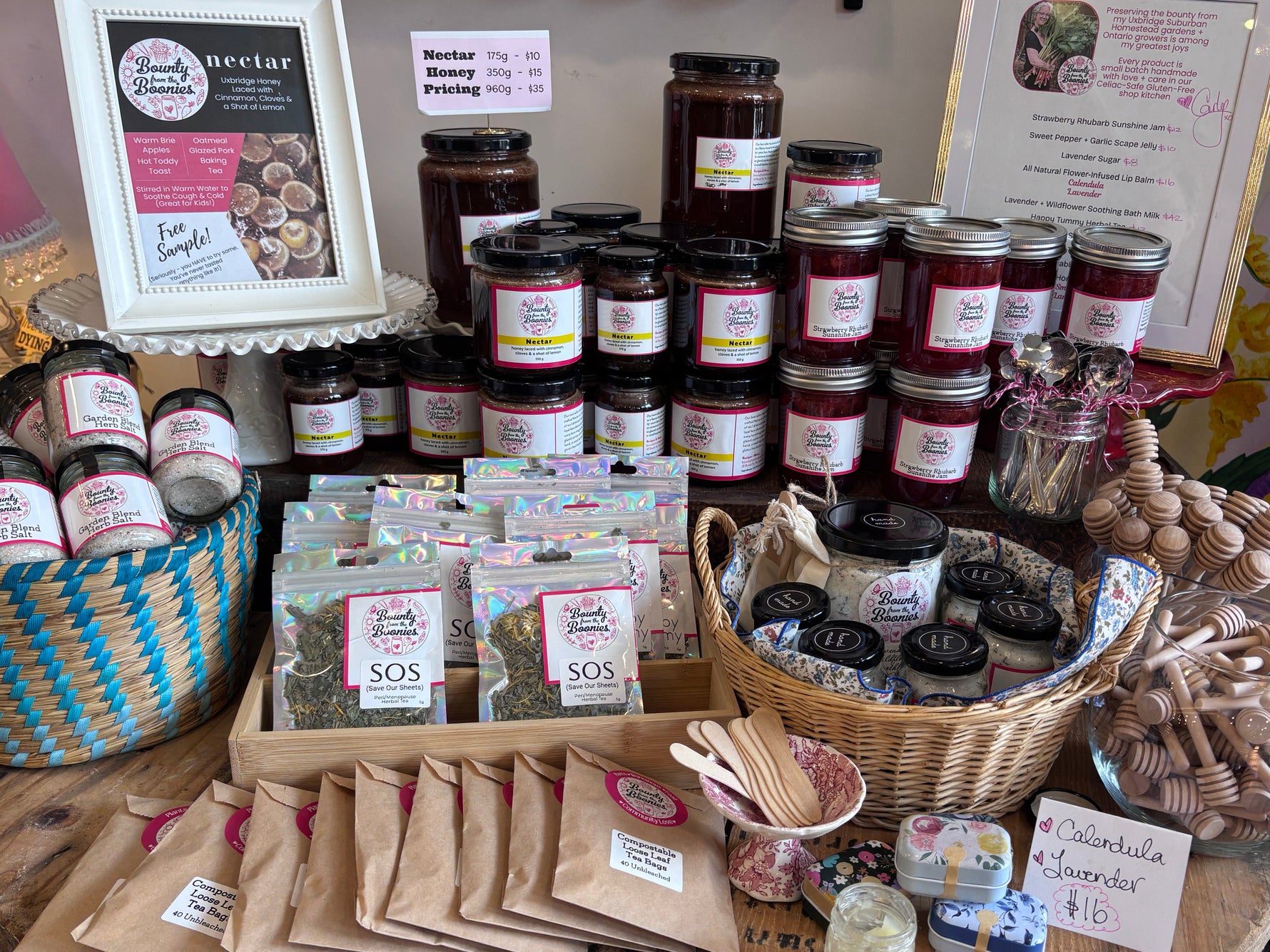 Table with various jars, containers, and packaging on a wooden surface.